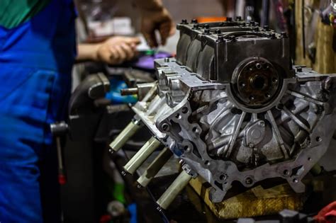 Premium Photo | A man works on a car engine.