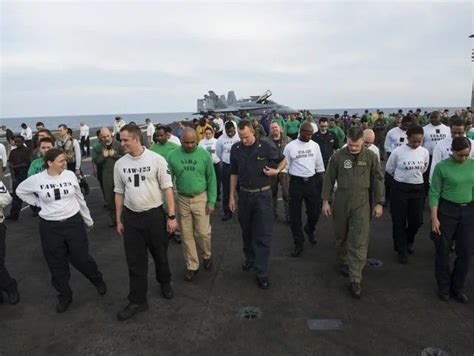 USS Eisenhower crew members walk the length of the flight deck. JACK ...