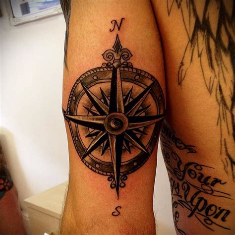 Nautical compass rose tattooed on the tricep. Not the best picture as ...