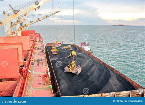 Loading Coal from Cargo Barges Onto a Bulk Carrier Using Ship Cranes ...