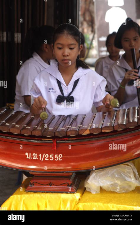 Thai student performing Ranat Ek (traditional Thai xylophone Stock ...