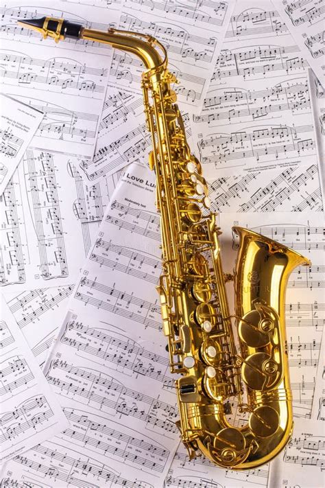 Saxophone Against A Background Of Sheet Music. Stock Image - Image of ...