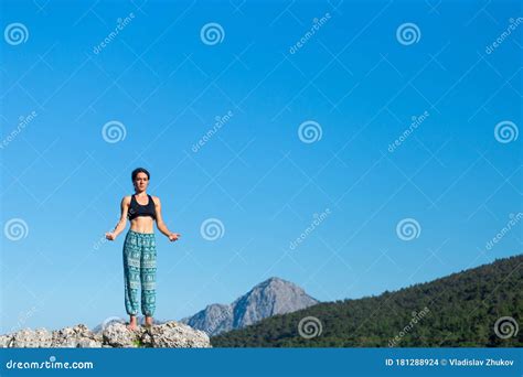 Girl Practices Yoga on Top of the Mountain Stock Photo - Image of ...