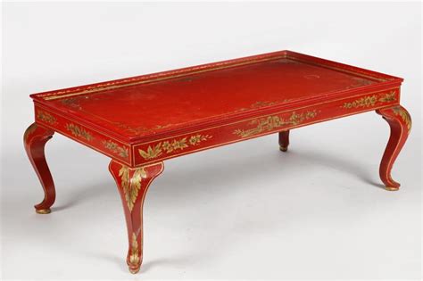 Lot - A parcel gilt decorated red painted coffee table 20th century