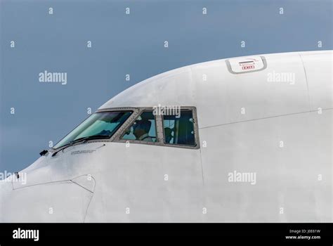 Jumbo jet Boeing 747 cockpit with pilots visible. Close uo Stock Photo ...