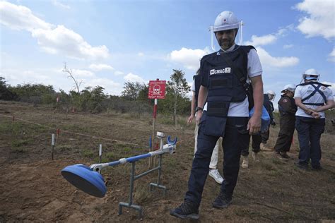 A Ukrainian soldier learning demining techniques from Cambodian experts ...