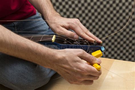 Guitarist Using the String Winder Stock Image - Image of professional ...