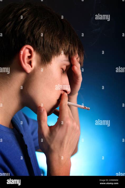 Sad Young Man with Cigarette in the Dark Room closeup Stock Photo - Alamy