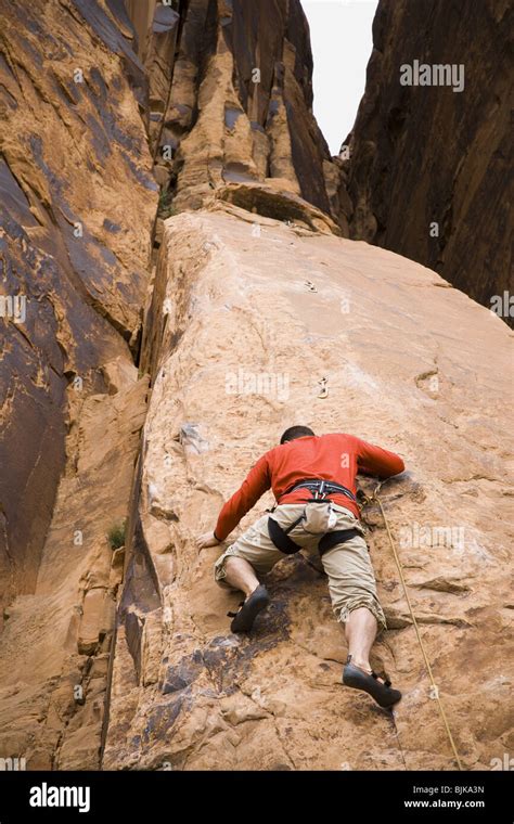 Man climbing mountain Stock Photo - Alamy