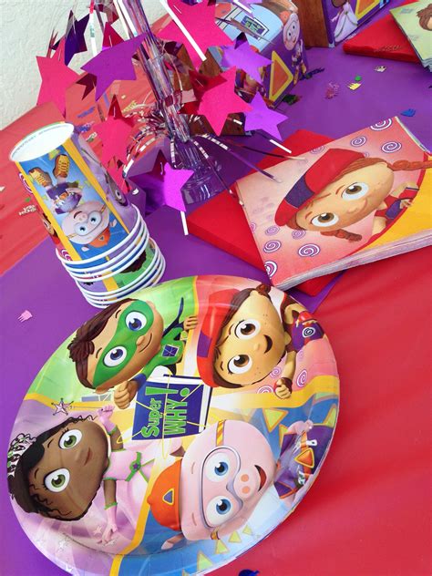 there is a paper plate with cartoon characters on it and other party ...