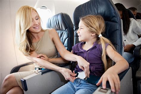 "Airplane: Mother Helps Child With Seatbelt" by Stocksy Contributor ...