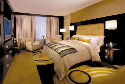 This gold and black hotel room with a king size bed is perfect for ...