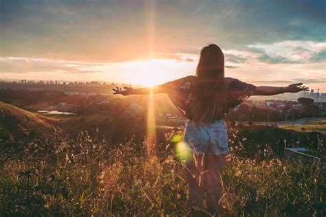 Woman Stands on Mountain over Field Under Cloudy Sky at Sunrise · Free ...