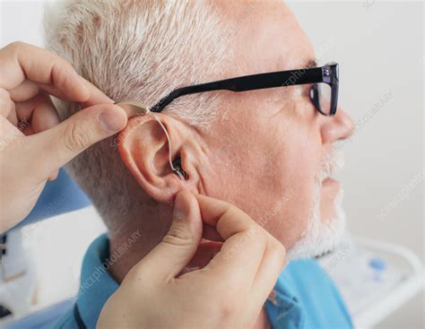 Hearing aid fitting - Stock Image - F036/2780 - Science Photo Library