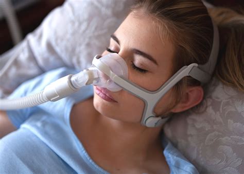 photo of a young woman sleeping with a CPAP mask on her face · ZaggoCare