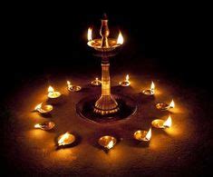 A big "Vilakku", surrounded by small lamps give a rustic South Indian ...