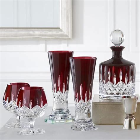 red glass vases and glasses sitting on a table