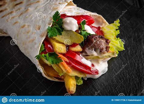 A Delicious Doner Donair Kebab Wrap with Meat, Lettuce, Tomato, Red ...