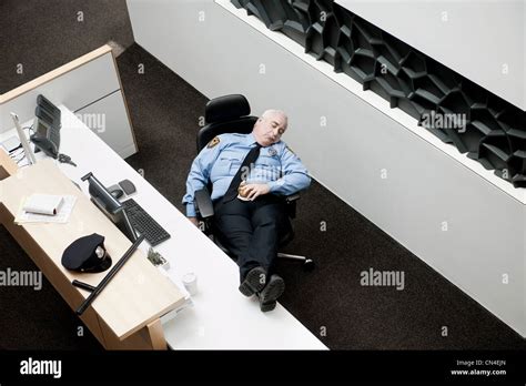 Security guard sleeping at desk Stock Photo - Alamy