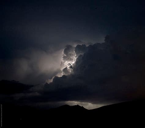 "Lightning Illuminates Clouds In A Stormy Night Sky" by Stocksy ...