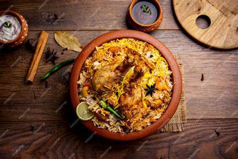 Premium Photo | Dum Handi chicken Biryani is prepared in an earthen or ...