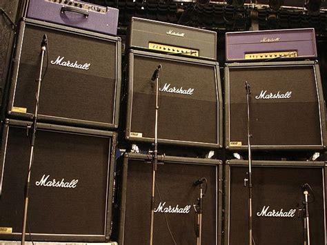 several marshall amps are lined up against the wall