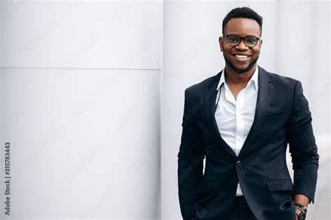 Smiling handsome african american man in stylish formal suit, outdoors Stock Photo | Adobe Stock