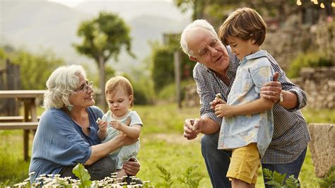 Grandparents talking to children in yard – Foundations Counseling