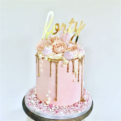 Pink buttercream cake with buttercream flowers including roses and ...