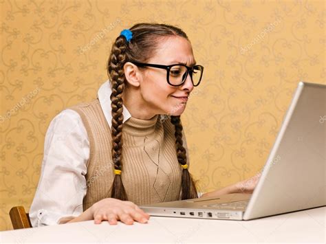 Young female nerd sitting on the computer — Stock Photo © nesharm #61112543