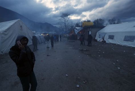 Migrants huddle in the cold in makeshift camp in Bosnia