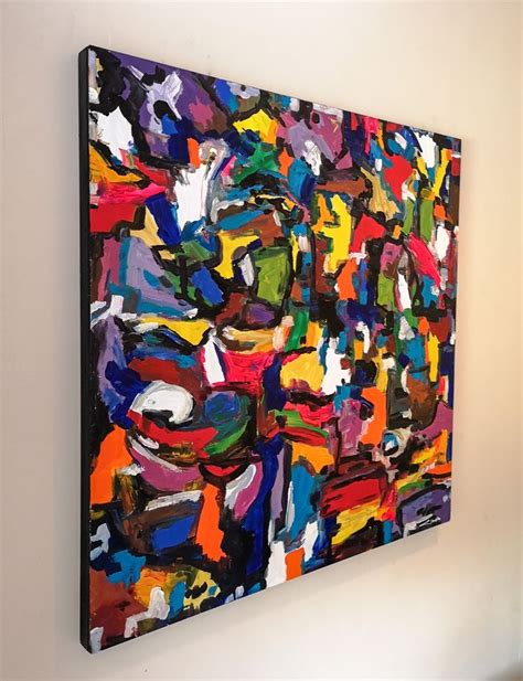 an abstract painting hangs on the wall