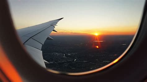 HD wallpaper: clear glass airplane window showing sunset with cloudy ...