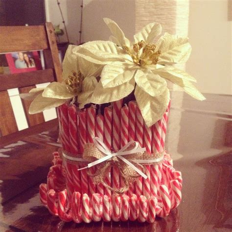 a stack of candy canes with flowers on top