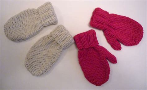 three knitted mittens and gloves on a table