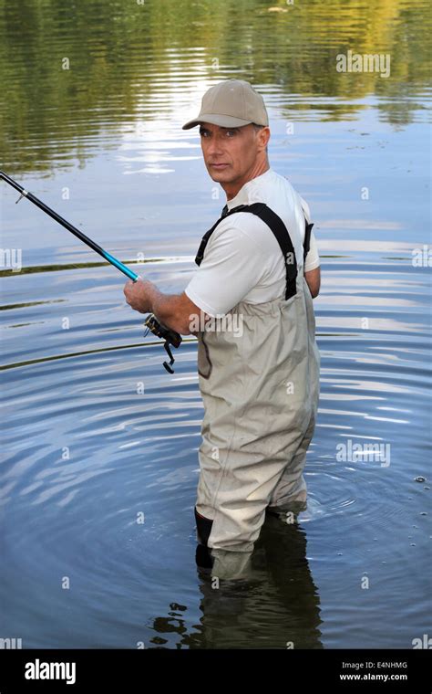 Man fishing in lake Stock Photo - Alamy