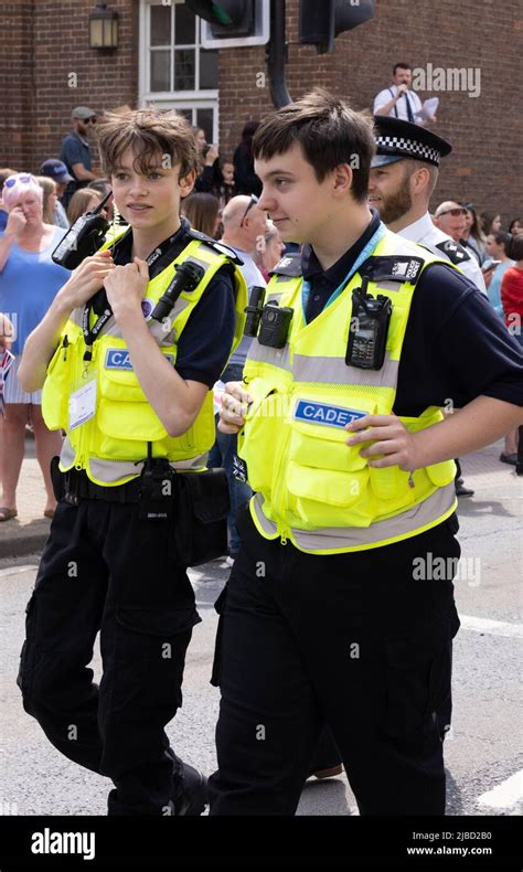 Police cadets UK; Two police cadet members walking in town, Newmarket ...