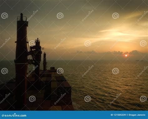 Container Ship at the Sunset, Sun Near the Horizont Editorial Stock ...