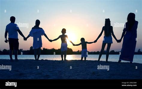 Silhouette of family on sunset background Stock Photo - Alamy