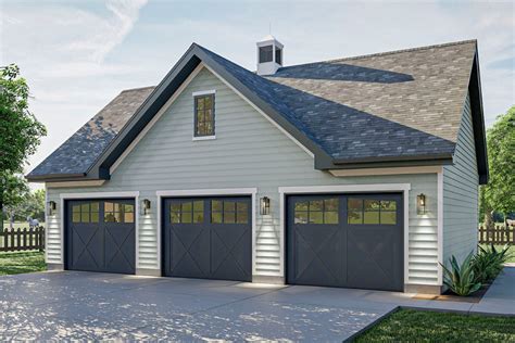 A broad gable sits atop the center of three garage doors in this ...