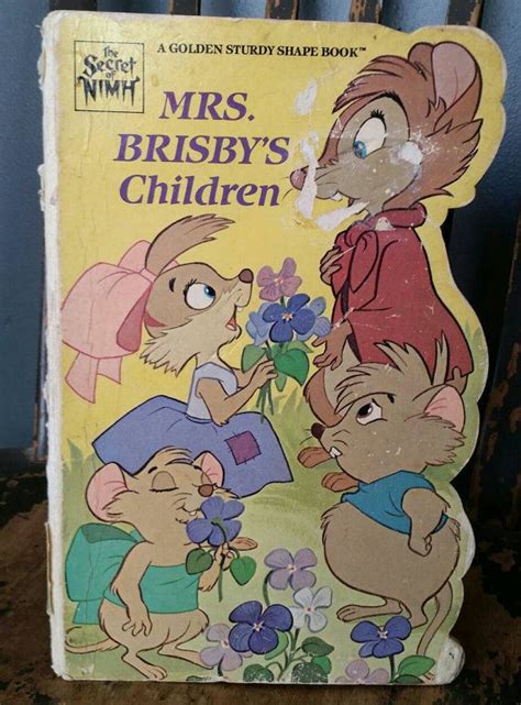 a hand holding up a children's book about the story of mrs brisby's ...