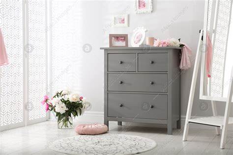 Grey chest of drawers in stylish room interior: Stock Photo | Download ...