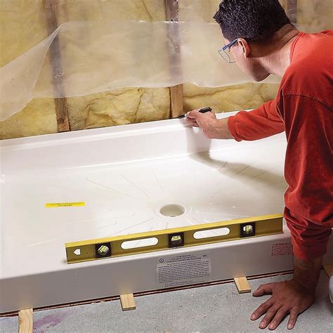 a man in red shirt painting a bathtub with white paint and yellow ...