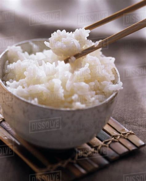 A Bowl of Cooked Rice with Chopsticks - Stock Photo - Dissolve