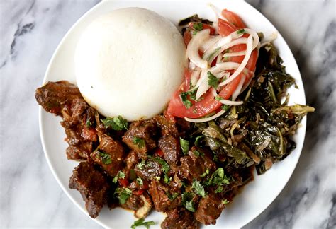 Kenyan Goat Wet Fry, Sukuma Wiki, Kachumbari and Ugali - Travelandmunchies