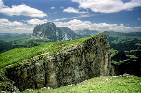 Grassy stone cliffs across cloudy mountains during daytime HD wallpaper ...