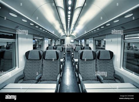 Interior view of modern intercity high speed train coach with rows of ...