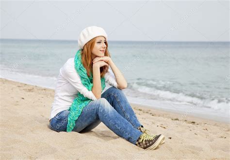 Young beautiful girl sitting at the beach — Stock Photo ...