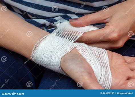 Young Woman Bandaging Her Wrist. Wound Care Bandage, Control Bleeding ...