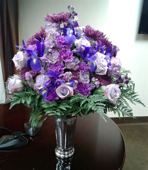 Purple flower arrangement, with iris, carnations, and lavender roses ...